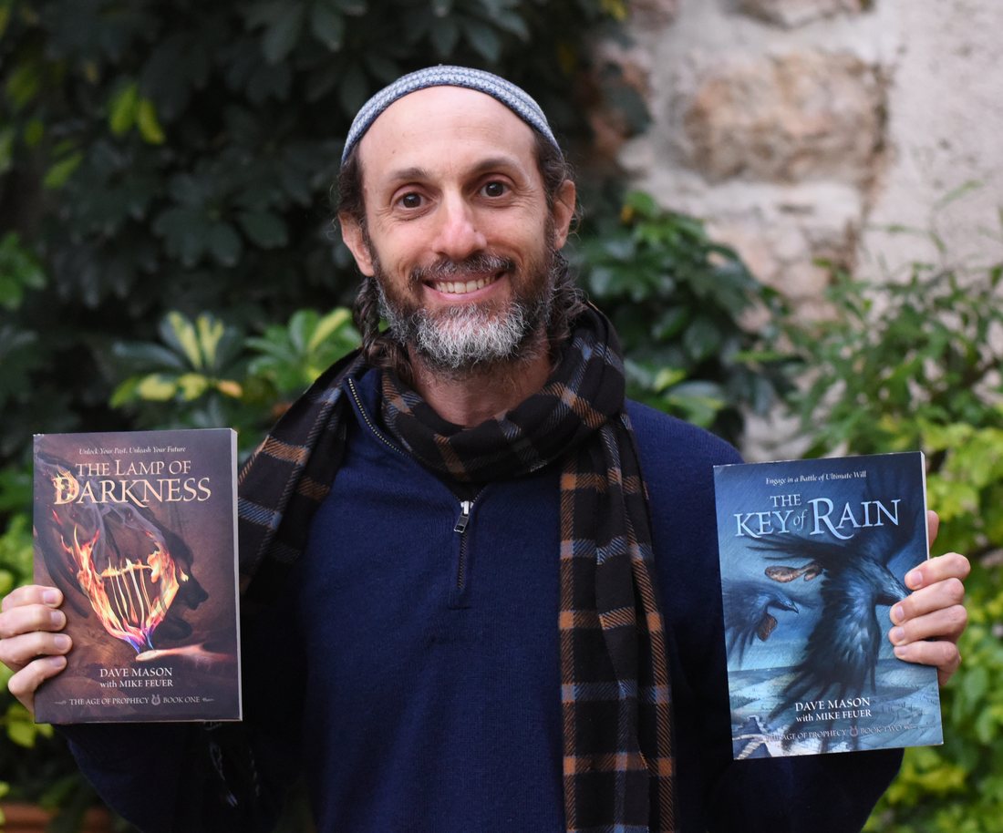 Dave Mason holding two of his novels
